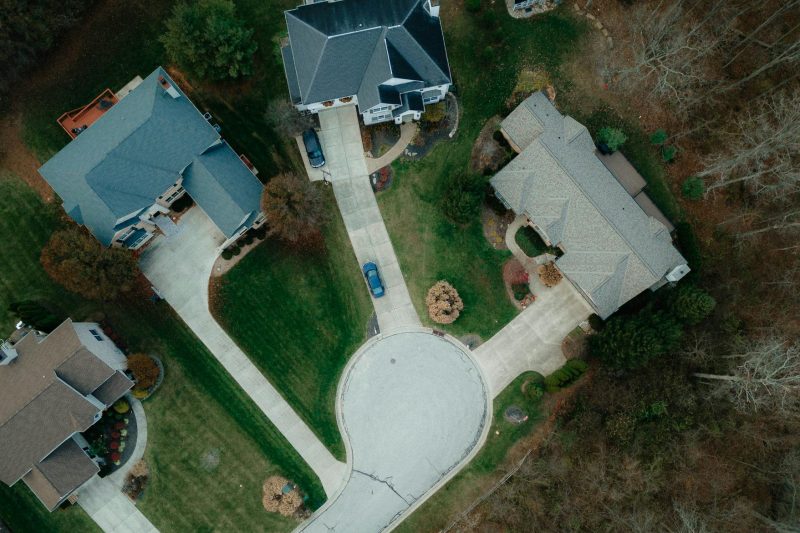 Aerial view of suburban Cincinnati featuring homes, tree-lined streets, and lush greenery.