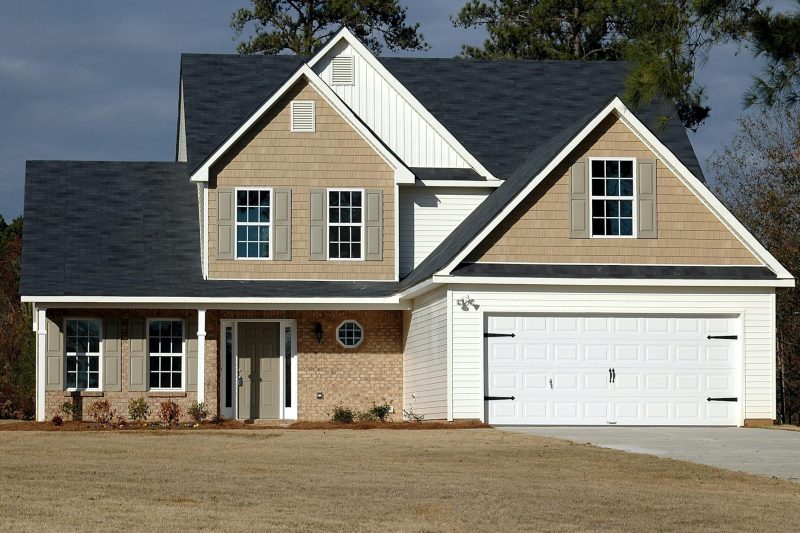Elegant two-storey house with a garage, featuring modern architecture and charming residential design.