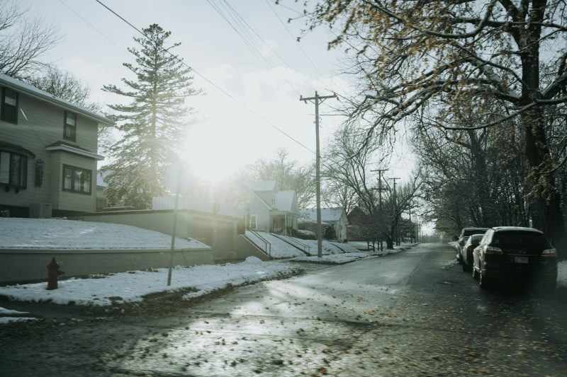 Frosty winter street in Dixon, IL, featuring residential houses and clear blue skies.