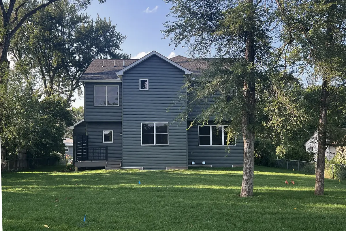 The Northstar 20 Back view of home with deck and fully landscaped