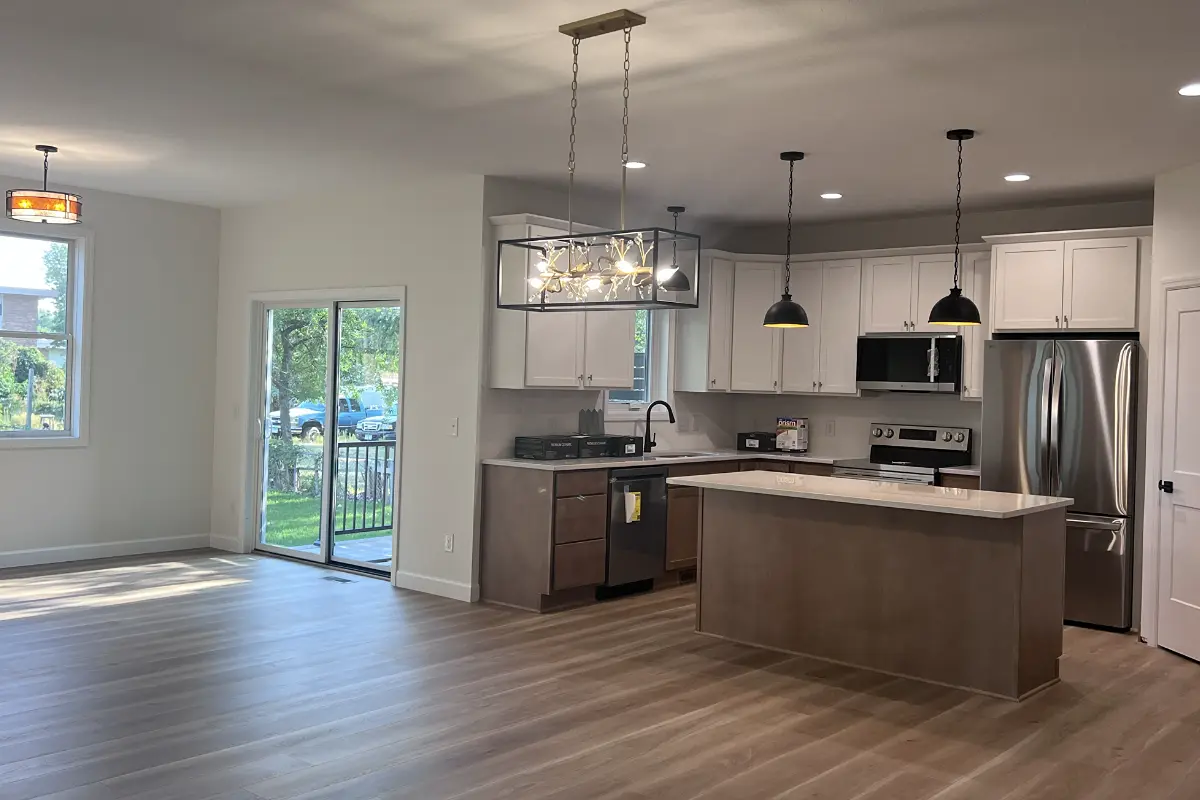 The Northstar 4 Dining area with chandelier and kitchen with large island and quartz countertops