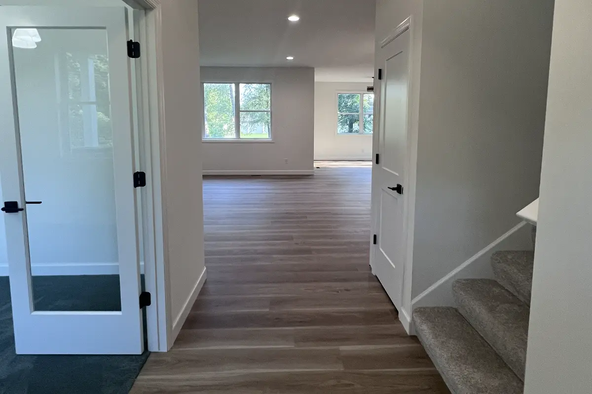 The Northstar 8 Entry way with office on left stairs to upper level on left and living room & sunroom straight ahead