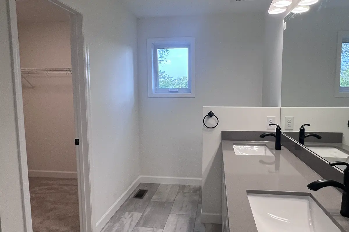 The Northstar 12 Primary bath with double sinks and window for natural light