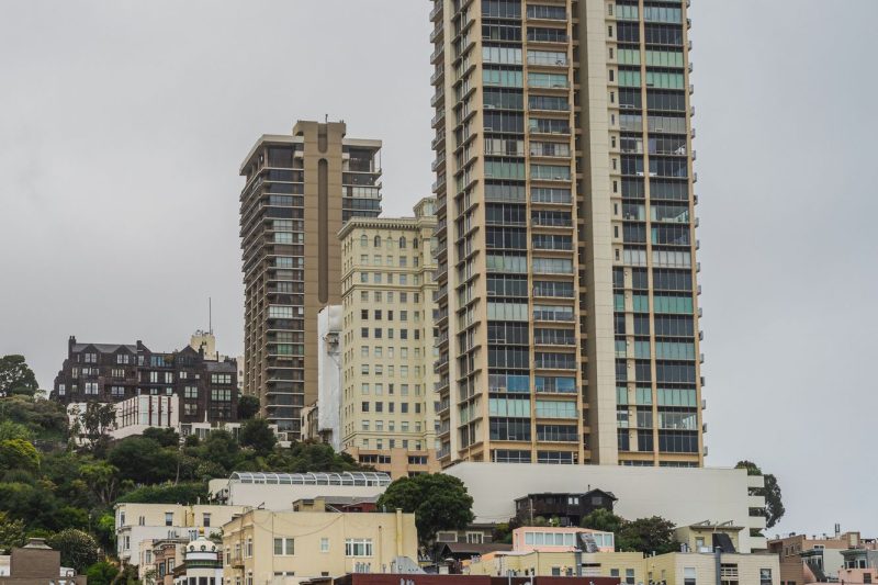 San Francisco cityscape showcasing modern residential towers and sleek architectural designs against a clear blue sky.