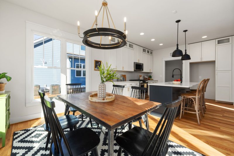 Bright, modern kitchen and dining area featuring stylish furnishings and abundant natural light.
